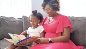 Lakeisha Johnson and her daughter Maya Johnson, 5, read a book together in their home.