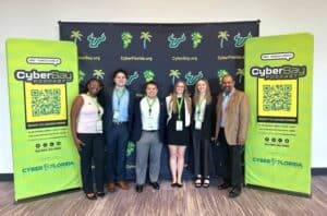 Group of people standing in front of CyberBay step-and-repeat