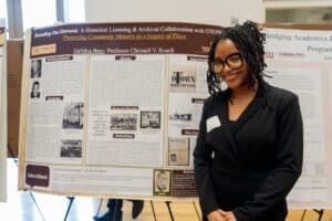 Da'Mya standing in front of her poster