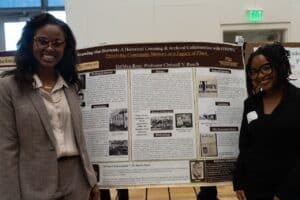 Professor Roach and Da'Mya standing in front of their poster