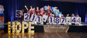 CCI Team on stage celebrating total funds raised